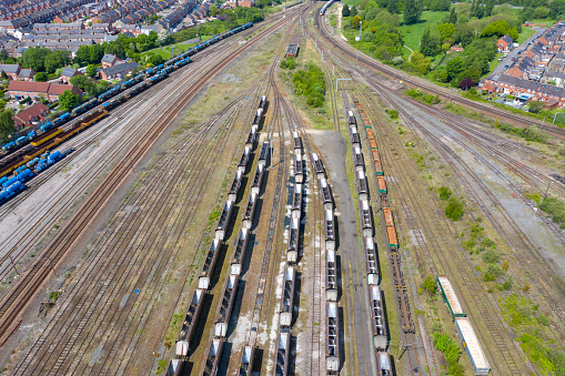 Aerial photo of a lot of hopper car / hopper wagon old rusty train cargo trucks on train tracks located in the town of York in West Yorkshire in the UK