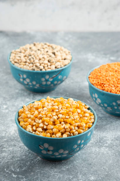 istock Raw red lentils, corns and white beans in blue bowls 1294198928