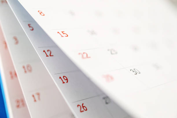 istock Calendar page flipping sheet close up on office table background business schedule planning appointment meeting concept 1294201468