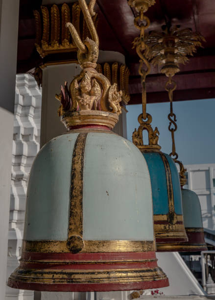 istock Ancient bells hanging on pillars outside in the thai temple. 1294201980