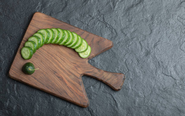 istock Wide angle sliced cucumber on black background 1294207742