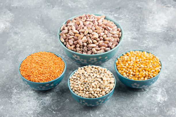 istock Blue bowls of various beans and corns on marble background 1294207837