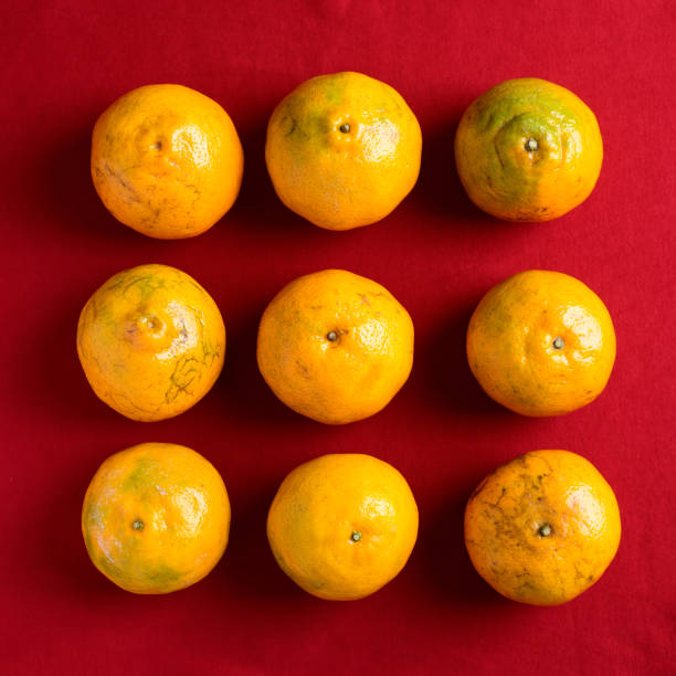 Tangerine orange fruit on red background, chinese New Year