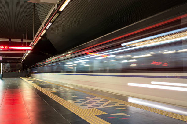 istock light trail of monorail passing by in station at night 1294220603