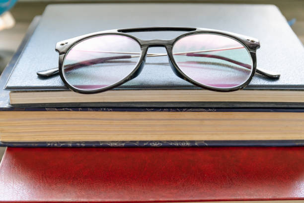 istock Reading glasses put on hardcover books 1294221306
