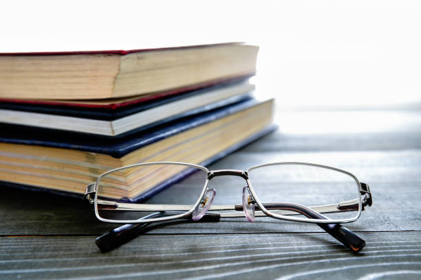istock Glasses and stack of hardcover books 1294221322