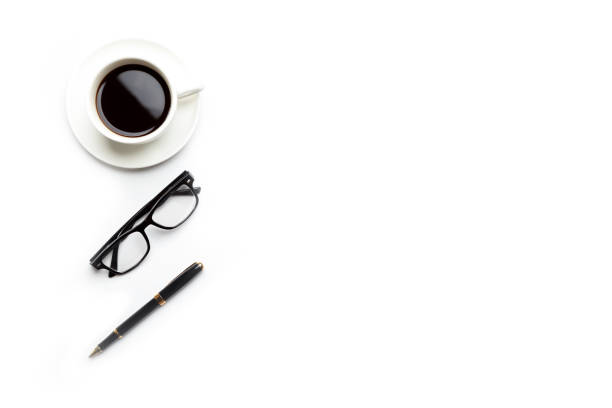 istock Flat lay, top view office table desk. Workspace with blank, office supplies, pencil, green leaf, and coffee cup on white background. 1294231425