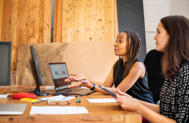 istock Young female business partners video calling a client to discuss their new project 1294232839