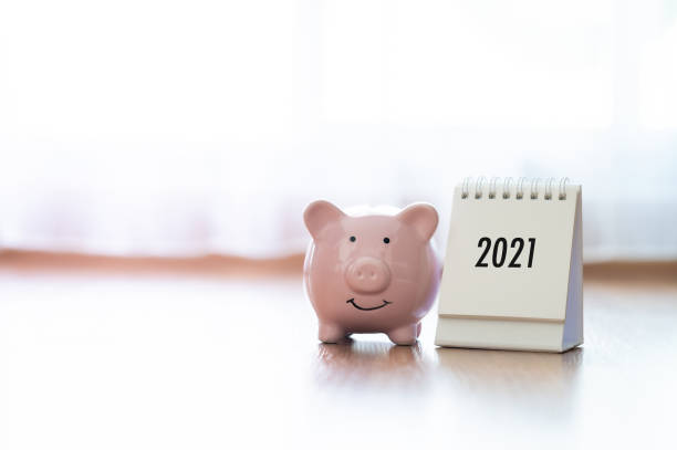 calendar year 2021 and piggy bank on wooden floor. concept finance business investment - stock market data insurance savings finance imagens e fotografias de stock