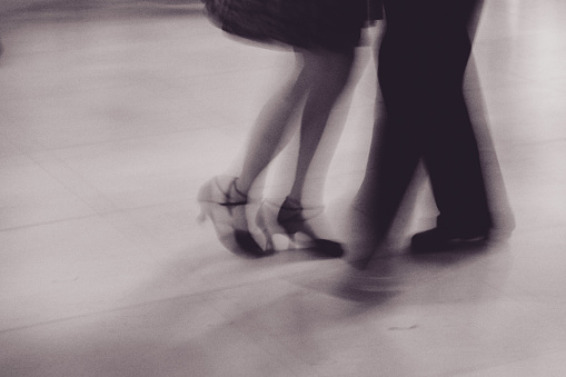 moving feet during tango dancing, black and white photo
