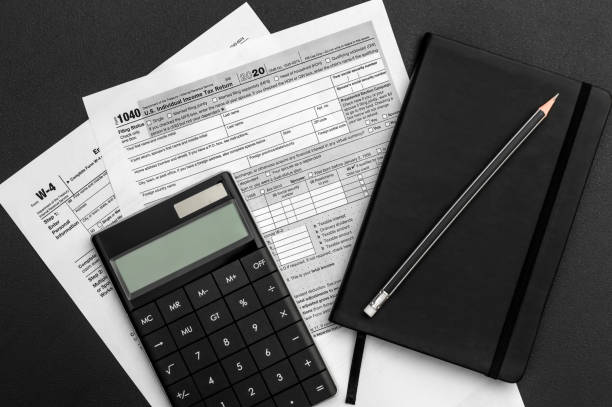 istock Tax forms with calculator and notepad on the office workplace. 1294237269