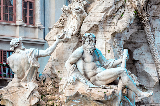 Sculptures of Fontana dei Quattro Fiumi Piazza Navona in Rome Italy . Sculptures of mythological gods . Marble craft figures
