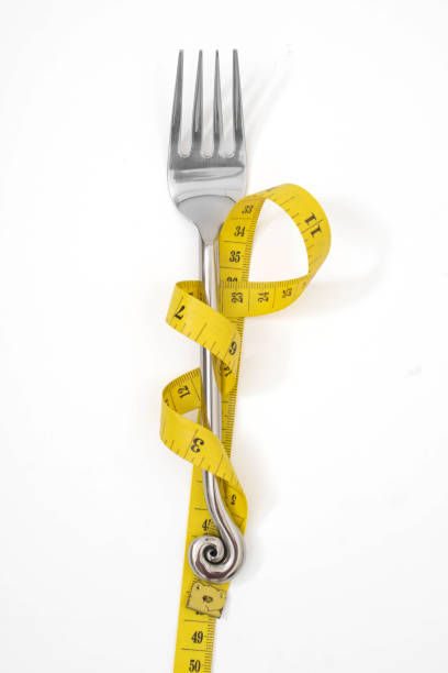istock fork with a measuring tape diet or healthy eating concept concept 1294239092