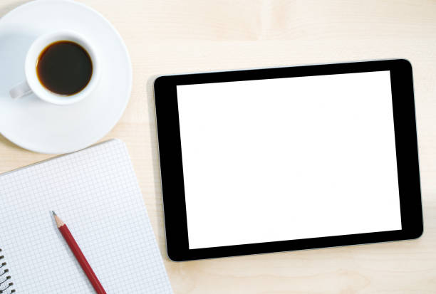 istock Tablet, coffee, notebook and pen on the desk. Top view. Telecommuting. Flat lay 1294239235
