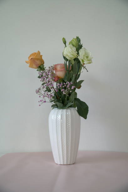 istock Artificial bouquet in white vase on table, interior decoration 1294240046