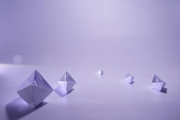 istock Handmade white paper boats combination arranged on gray background, copy space 1294243038