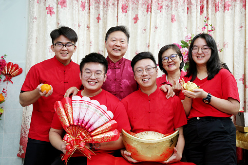An Asian family members are feeling joyful celebrating Chinese New Year at home.