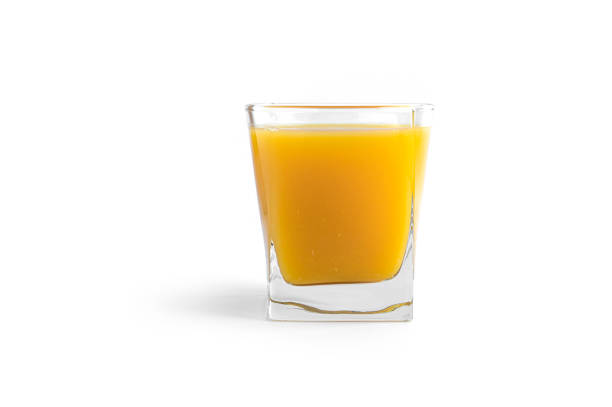 istock Orange juice in glass on a white background 1294244909