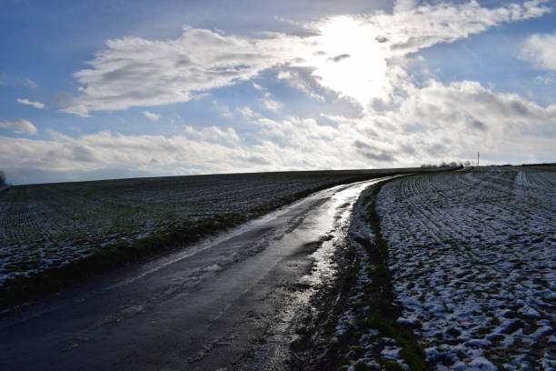 istock straight road through snow covered landscape 1294244971