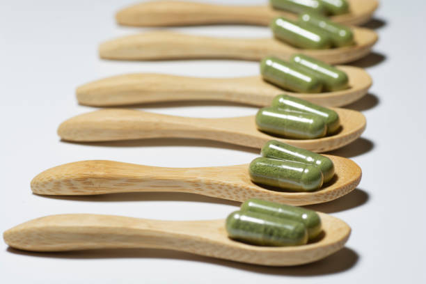 istock Moringa capsules on bamboo spoons  isolated on white background. 1294247026