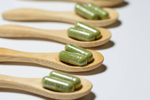 istock Moringa capsules on bamboo spoons  isolated on white background. 1294247032