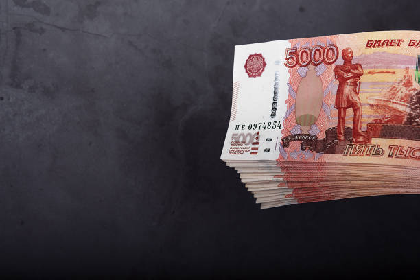 istock Russian cash banknotes of five thousand rubles, the bundle hangs on a gray background. 1294248047