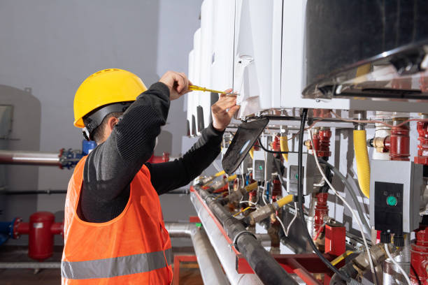 istock Technician is fixing the heaters with his yellow helmet. 1294249720