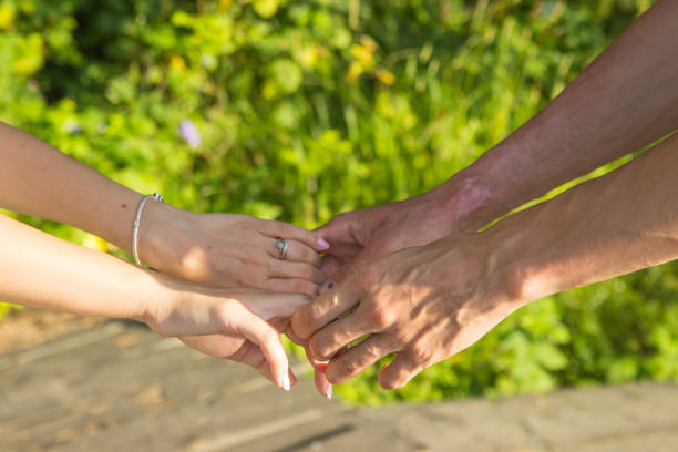istock Lovers couple holding hands in a forest summer spring 1294250643