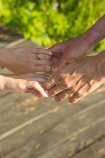 istock Lovers couple holding hands in a forest summer spring 1294251414