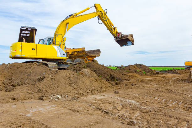 istock Excavator is loading a truck with ground on building site 1294252651