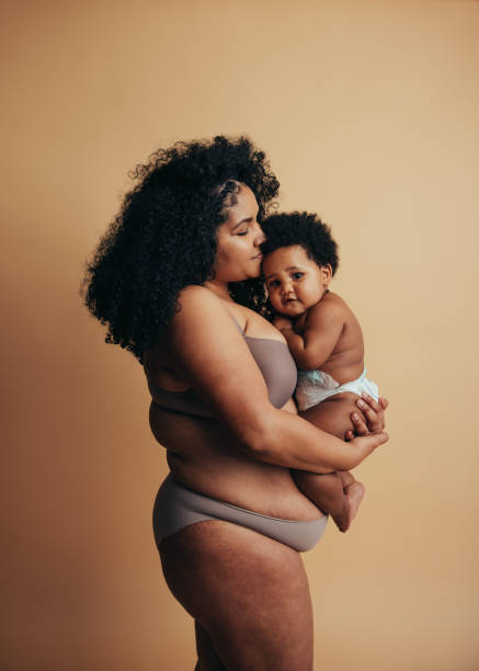 African American woman and baby African American woman and baby. Mother holding her cute baby in her arms. postpartum depression stock pictures, royalty-free photos & images