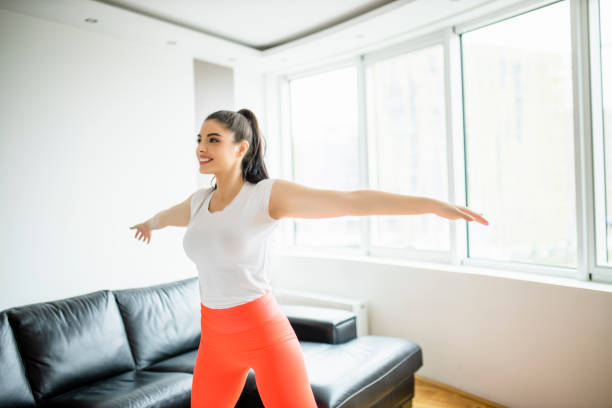 istock Young woman doing home workout in living room 1294253502