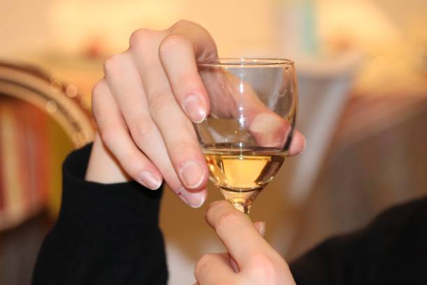 istock Hand holding a glass of wine 1294253536