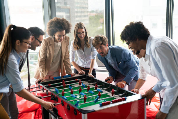 istock Employees playing table soccer indoor game in the office during break time 1294253544