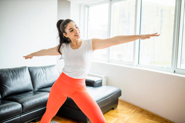 istock Slim beautiful woman doing lunges during home workout 1294253649
