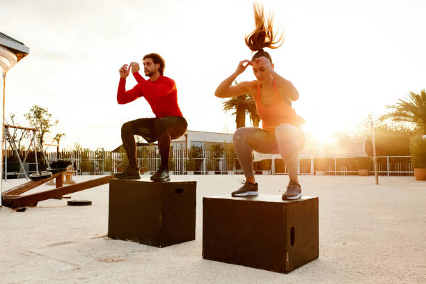 istock Two People Jumping On Crates During Cross Training In The Outdoors Gym 1294253683