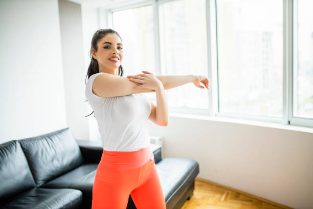 istock Fit woman exercising and stretching at home 1294254307