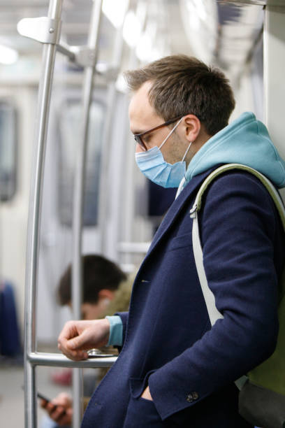 istock man wearing protective mask in public transport 1294255960
