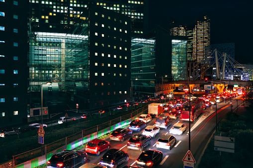 Traffic jam in the night city . Illuminated street of modern city .