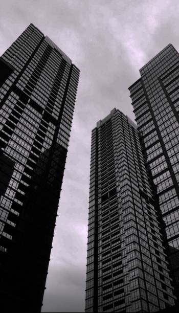 three towering buildings Three buildings towering under the overcast sky joule stock pictures, royalty-free photos & images