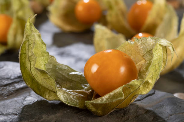 istock Cape gooseberry - physalis on a black stone background 1294258597