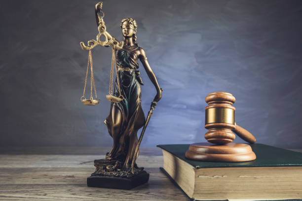 istock Justice symbols on wooden background 1294258705