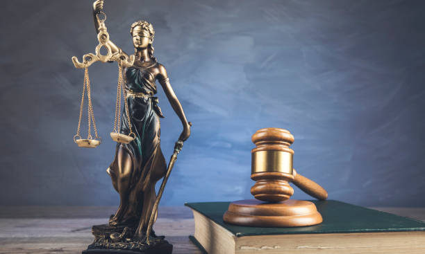 istock Justice symbols on wooden background 1294258714