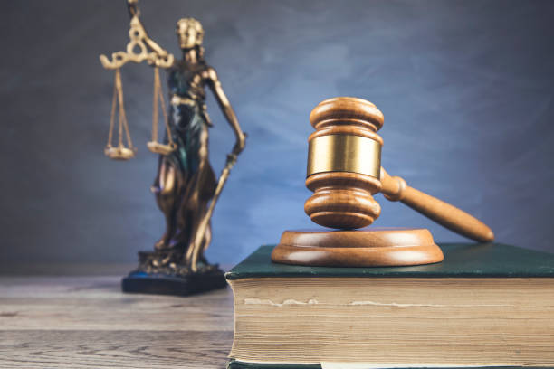 istock Justice symbols on wooden background 1294258719