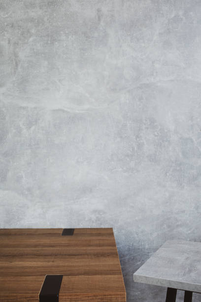 istock wooden desk table or shelf near concrete painted wall background texture surface, front view of tabletop 1294259037