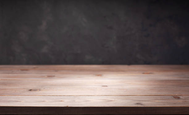 istock wooden desk table or shelf near concrete painted wall background texture surface, front view of tabletop 1294259039