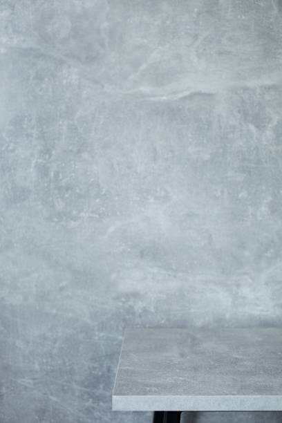 istock wooden desk table or shelf near concrete painted wall background texture surface, front view of tabletop 1294259097