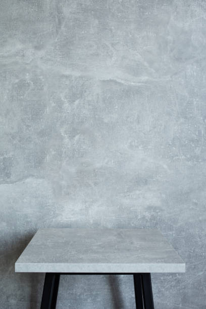 istock wooden desk table or shelf near concrete painted wall background texture surface, front view of tabletop 1294259109