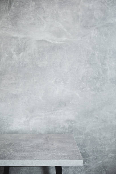 istock wooden desk table or shelf near concrete painted wall background texture surface, front view of tabletop 1294259117