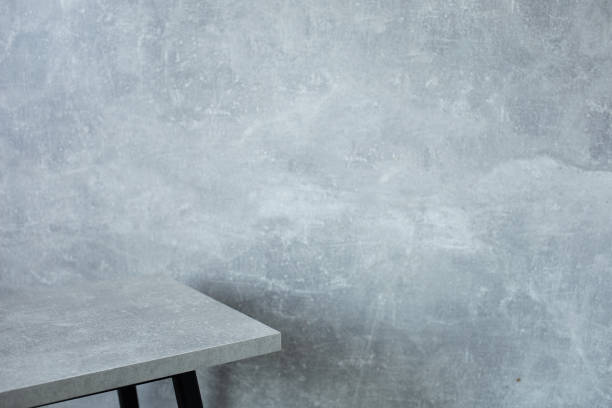 istock wooden desk table or shelf near concrete painted wall background texture surface, front view of tabletop 1294259120